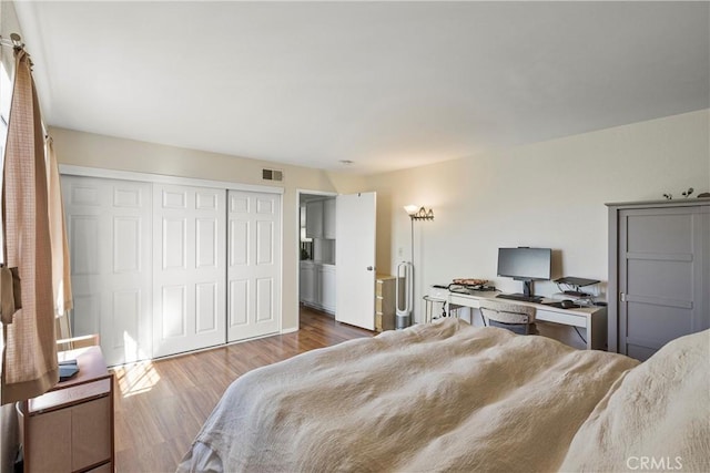 bedroom featuring hardwood / wood-style flooring and a closet