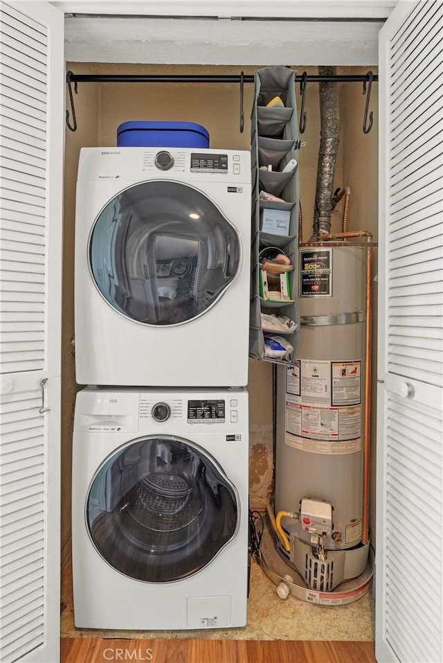 laundry room with stacked washer / dryer and strapped water heater