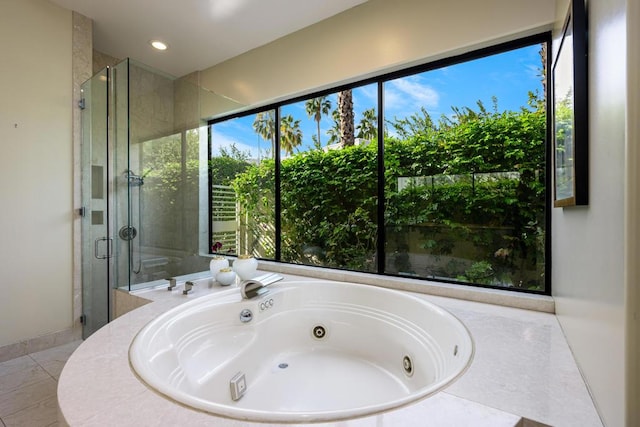 bathroom with tile patterned floors and independent shower and bath