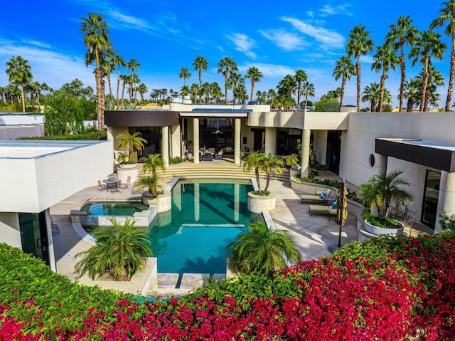 view of swimming pool featuring an in ground hot tub and a patio area