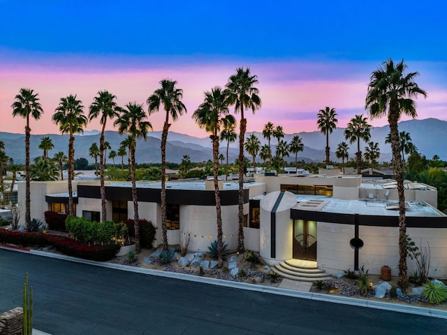 outdoor building at dusk with a mountain view