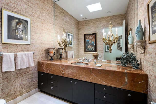 bathroom with vanity and a skylight