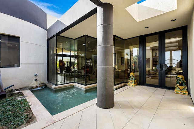 view of pool featuring a patio and french doors