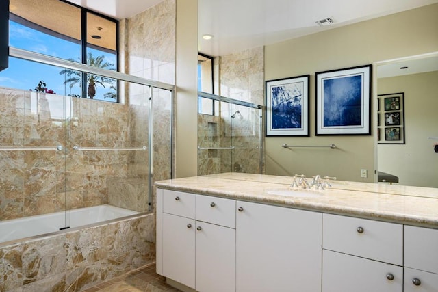 bathroom with vanity and bath / shower combo with glass door