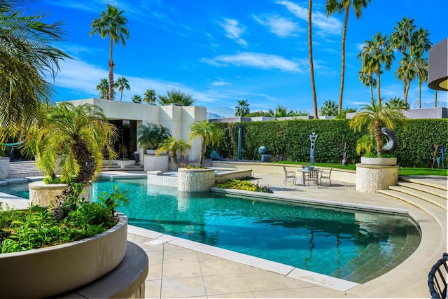 view of pool with a patio and an in ground hot tub