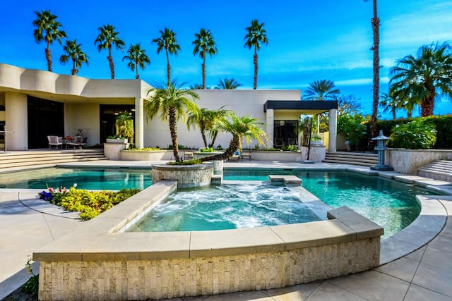 view of pool featuring an in ground hot tub and a patio