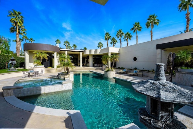 view of pool with an in ground hot tub and a patio area