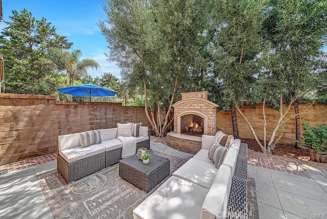 view of patio featuring an outdoor living space with a fireplace