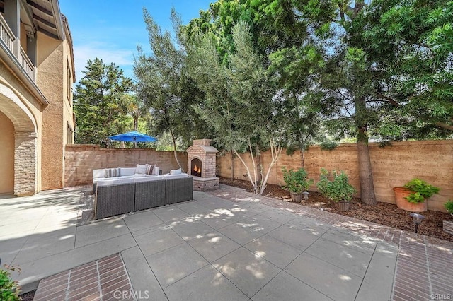 view of patio / terrace featuring an outdoor living space with a fireplace