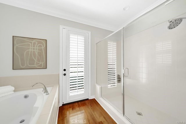 bathroom with crown molding, wood-type flooring, and shower with separate bathtub