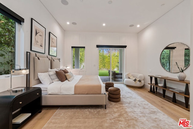 bedroom with light wood-type flooring and access to outside