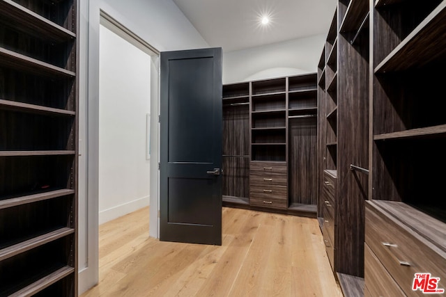 spacious closet with light hardwood / wood-style floors