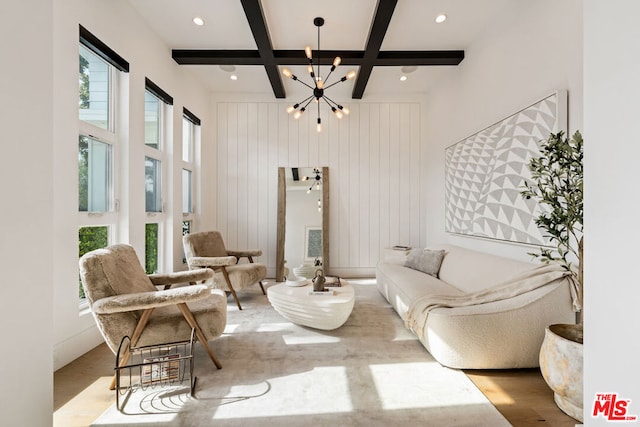 living room featuring coffered ceiling, beam ceiling, a chandelier, and hardwood / wood-style flooring