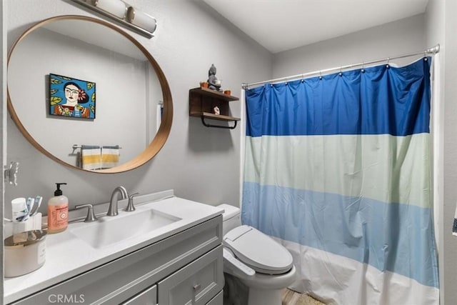 bathroom featuring vanity, toilet, and a shower with shower curtain