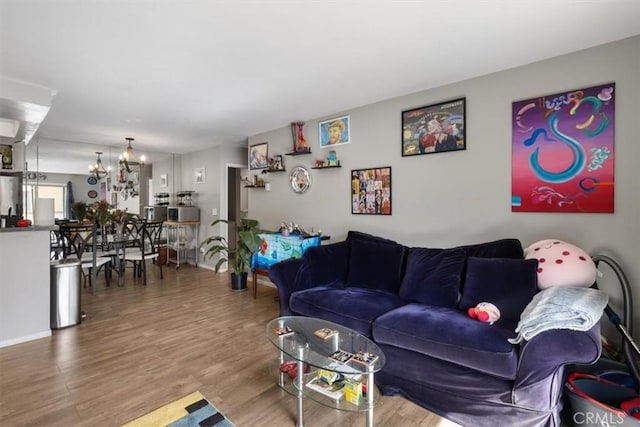 living room featuring an inviting chandelier and hardwood / wood-style flooring