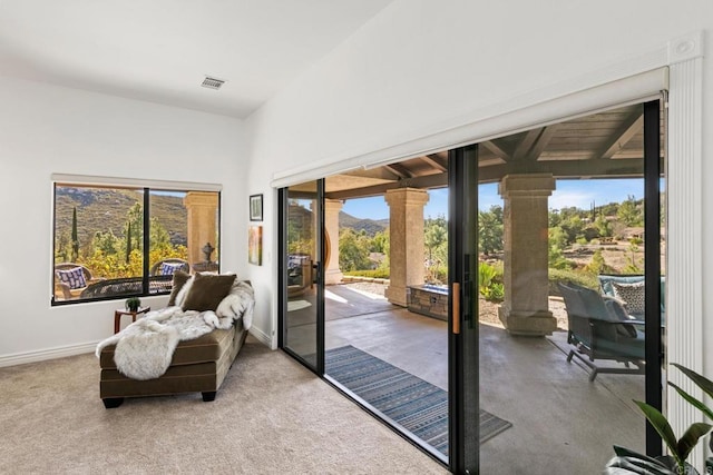 entryway with lofted ceiling and a mountain view