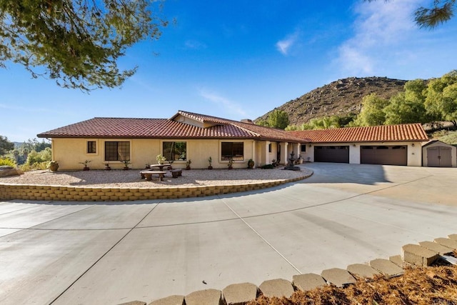 view of front of house with a garage and a mountain view