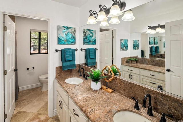 bathroom with vanity, toilet, and tile patterned flooring