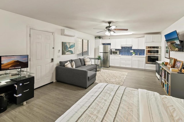 living room featuring ceiling fan, dark wood-type flooring, and a wall unit AC