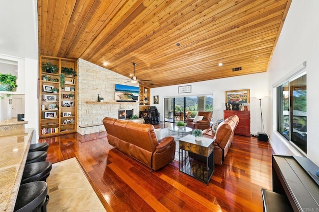 living room with lofted ceiling, wood ceiling, ceiling fan, a fireplace, and hardwood / wood-style floors