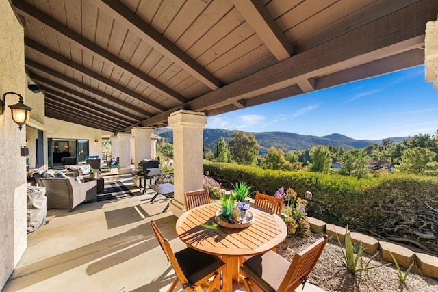 view of patio / terrace featuring a mountain view and an outdoor hangout area