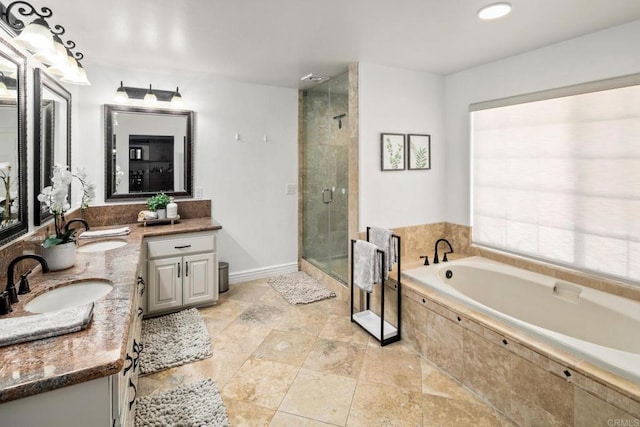 bathroom with vanity and shower with separate bathtub