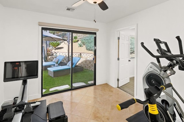 exercise area with ceiling fan and light tile patterned floors