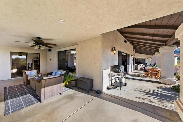 view of patio / terrace with ceiling fan and an outdoor living space