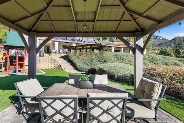 view of patio / terrace with a mountain view, a gazebo, and a playground