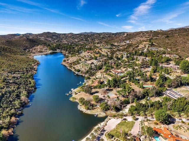 birds eye view of property with a water and mountain view