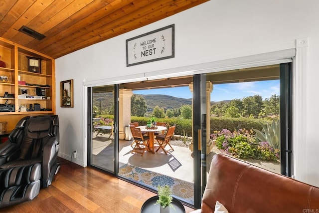 doorway with wood ceiling, a mountain view, vaulted ceiling, and hardwood / wood-style flooring