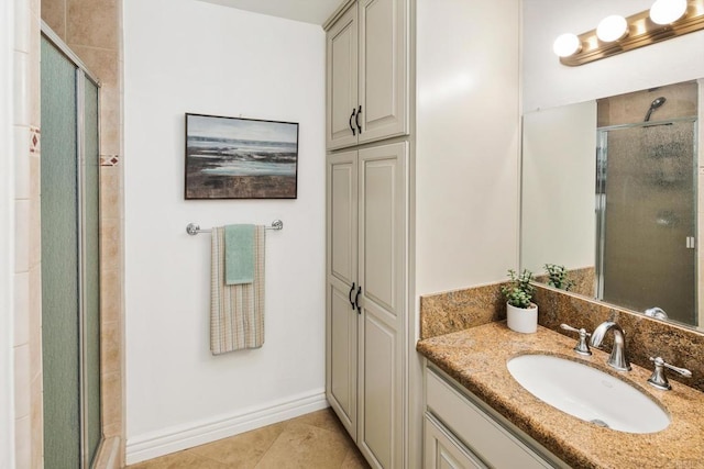 bathroom featuring tile patterned floors, vanity, and a shower with shower door