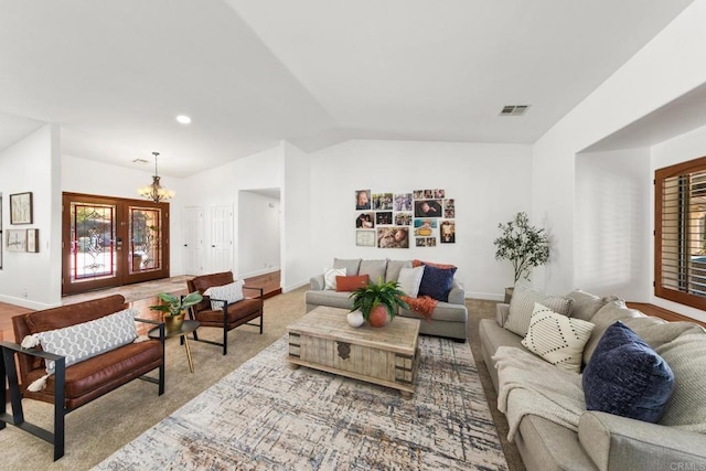 living room with lofted ceiling and a chandelier