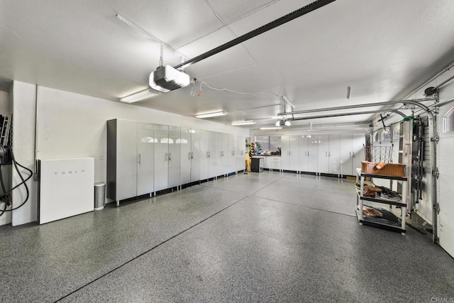 garage featuring fridge and a garage door opener