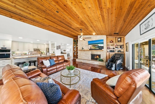 living room with lofted ceiling, sink, wood ceiling, a fireplace, and light hardwood / wood-style floors