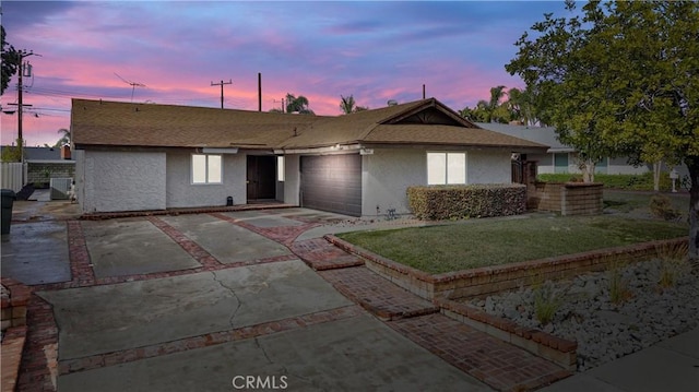 ranch-style home with a garage, cooling unit, and a lawn