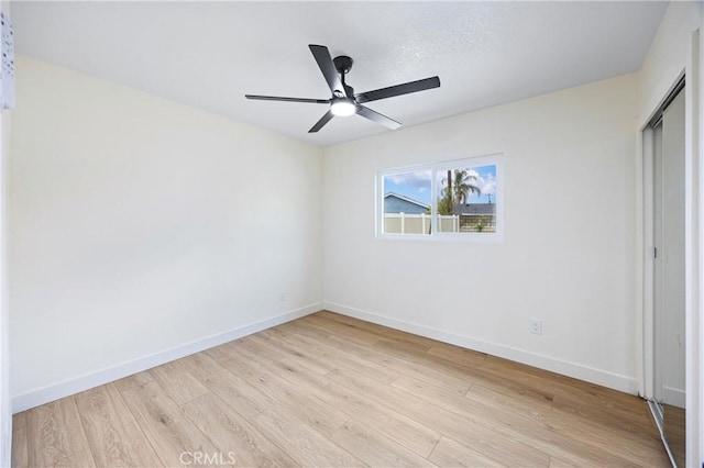 unfurnished bedroom with light hardwood / wood-style floors, a closet, and ceiling fan