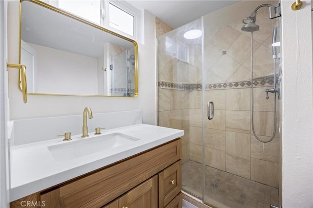 bathroom featuring vanity and a shower with door