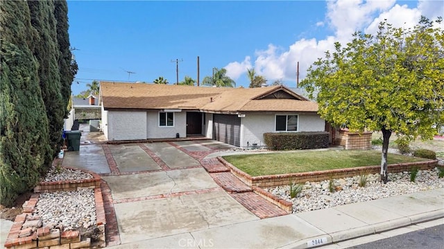 single story home featuring a garage and a front lawn