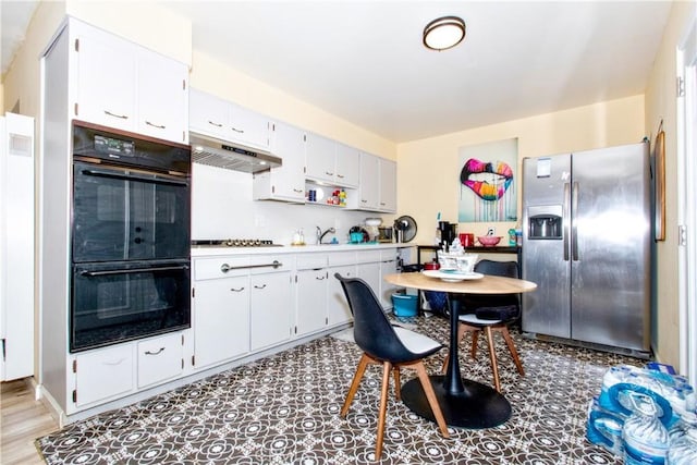 kitchen with white cabinets and black appliances