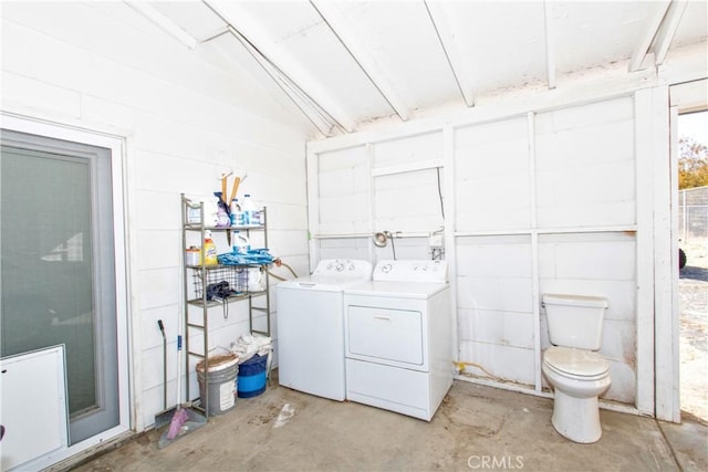 bathroom with toilet, concrete flooring, and washer and clothes dryer