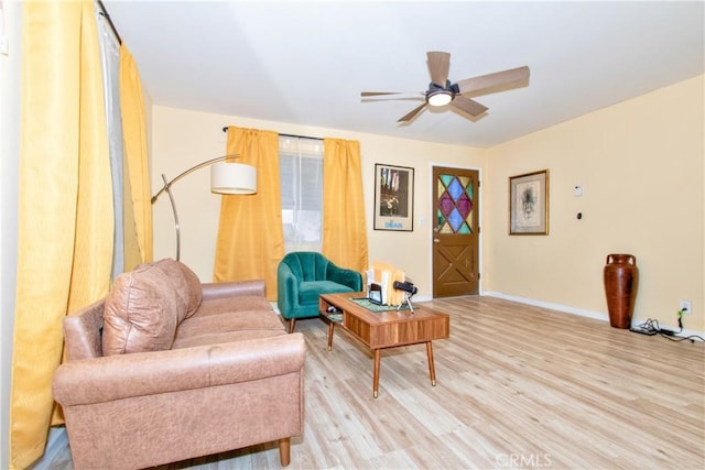 living room with ceiling fan and light hardwood / wood-style flooring