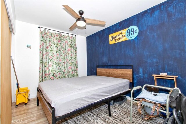 bedroom featuring ceiling fan and light hardwood / wood-style flooring