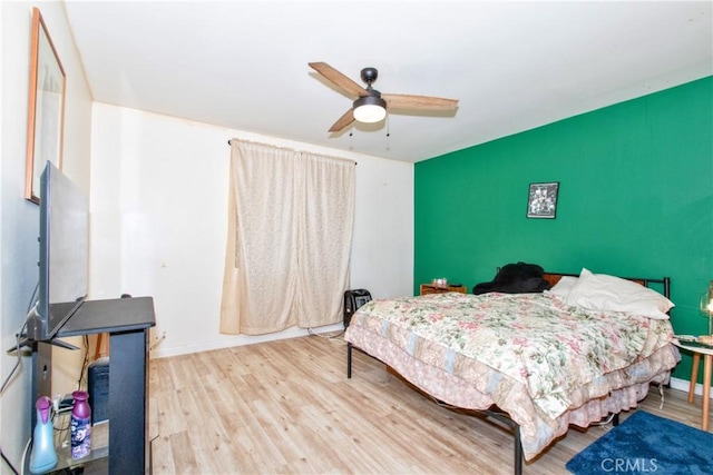 bedroom with hardwood / wood-style flooring and ceiling fan