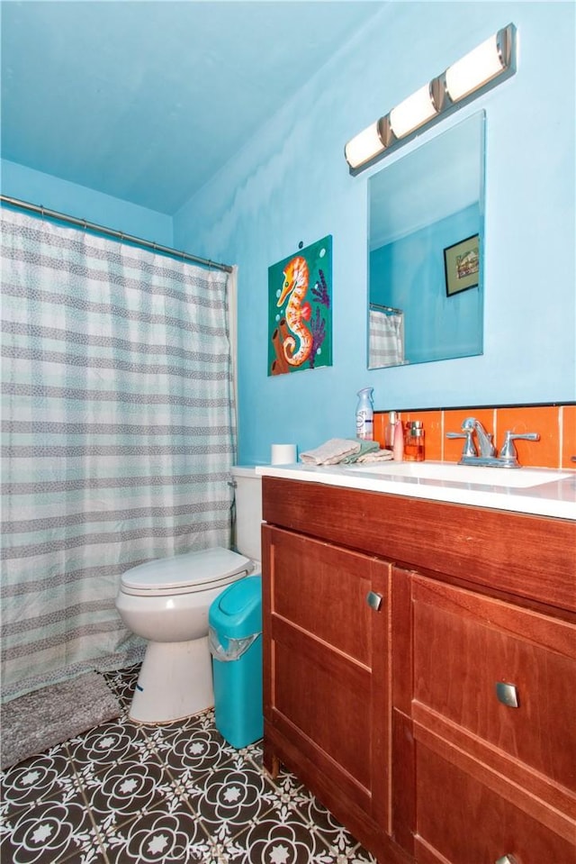 bathroom with tile patterned flooring, vanity, and toilet