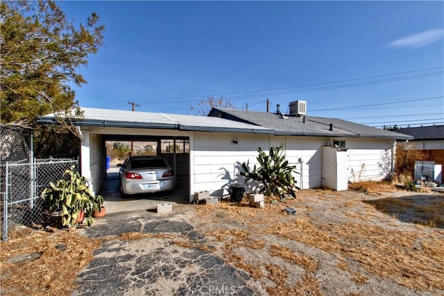 exterior space featuring central AC unit and a carport