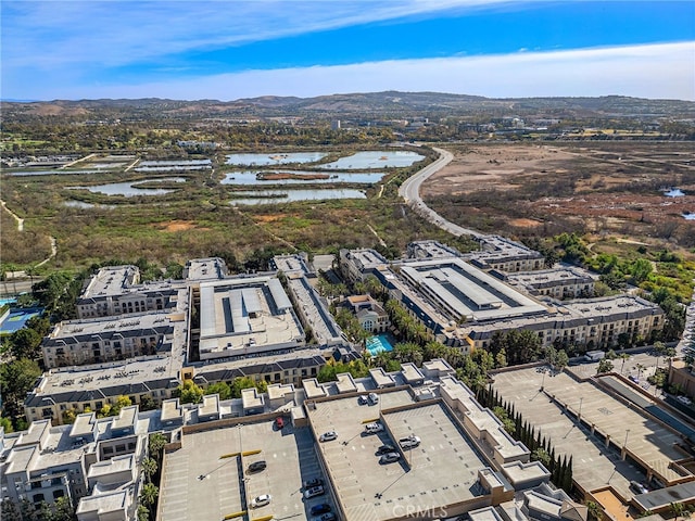 birds eye view of property with a water and mountain view