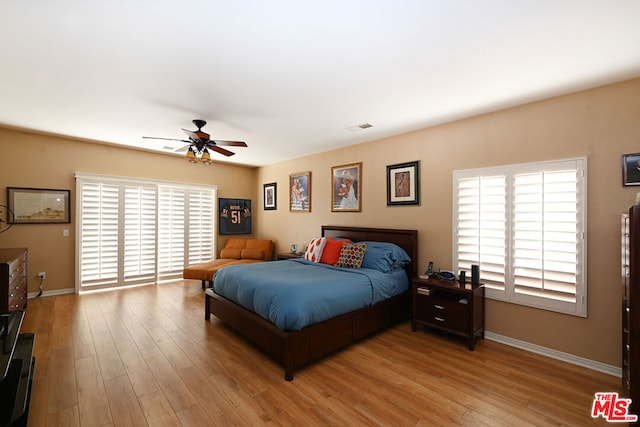 bedroom with ceiling fan and light wood-type flooring