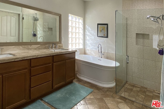 bathroom featuring vanity and separate shower and tub