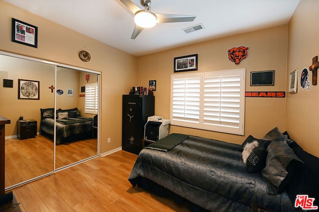 bedroom featuring ceiling fan, a closet, and light wood-type flooring